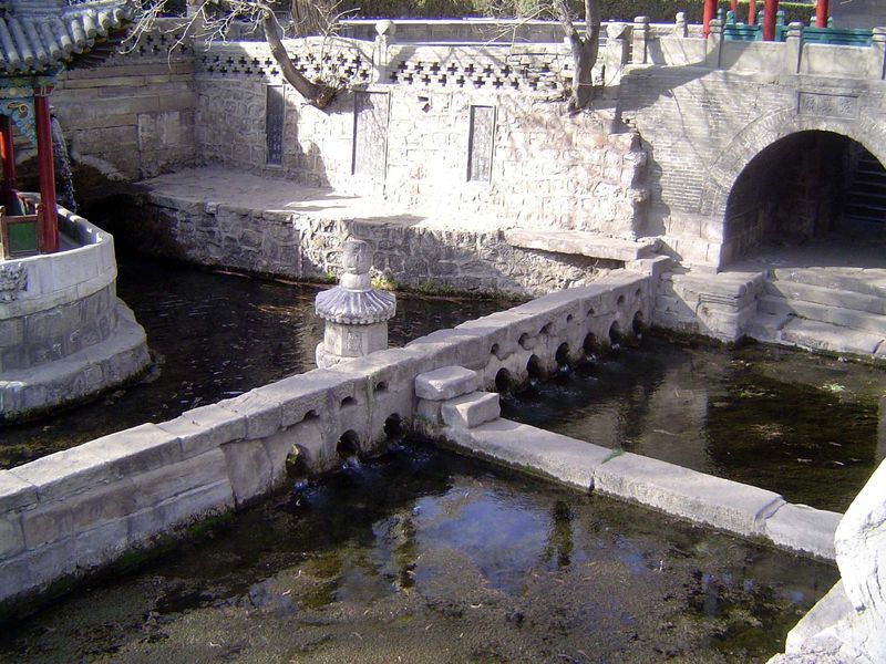 Immediately below the springs, the waters are divided into shares, physically separated as shown here by three holes to one side, seven to t