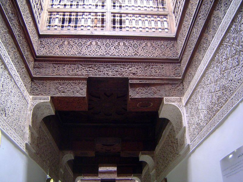 Above the entrance hall, light wells are walled with elaborately carved plaster and cedar.