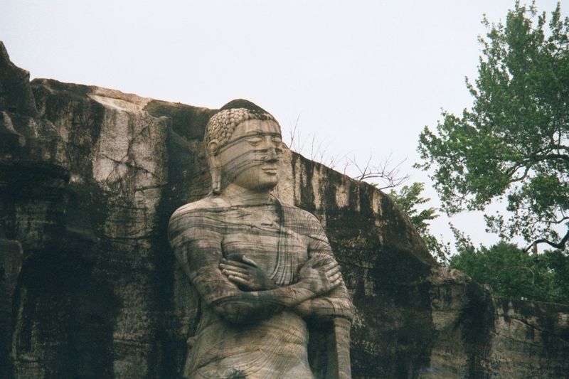 The standing figure was formerly interpreted as the Buddha's disciple Ananda.
