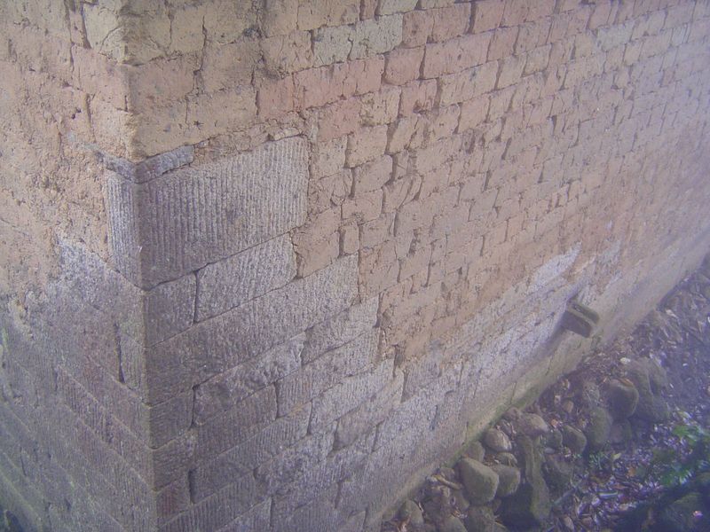 At the base, and especially at the corners, stone is used to resist erosion. Locally, nobody builds this way anymore.
