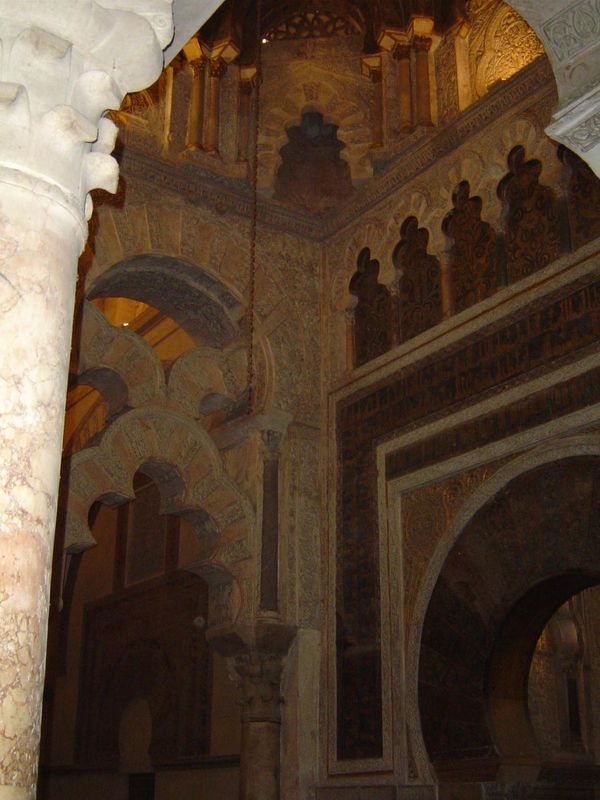 The mihrab is shown here at an angle to hint at the opulence of the \maksurah.

The mihrab is usually built in a wall perpendicular to the q