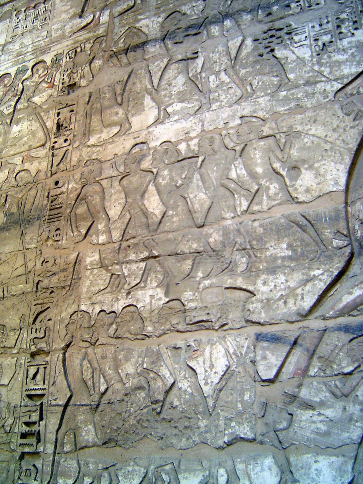 The other walls are devoted to the pharoah's invincibility. Bound prisoners, their hairstyle indicating Palestinian origin, are led to capti