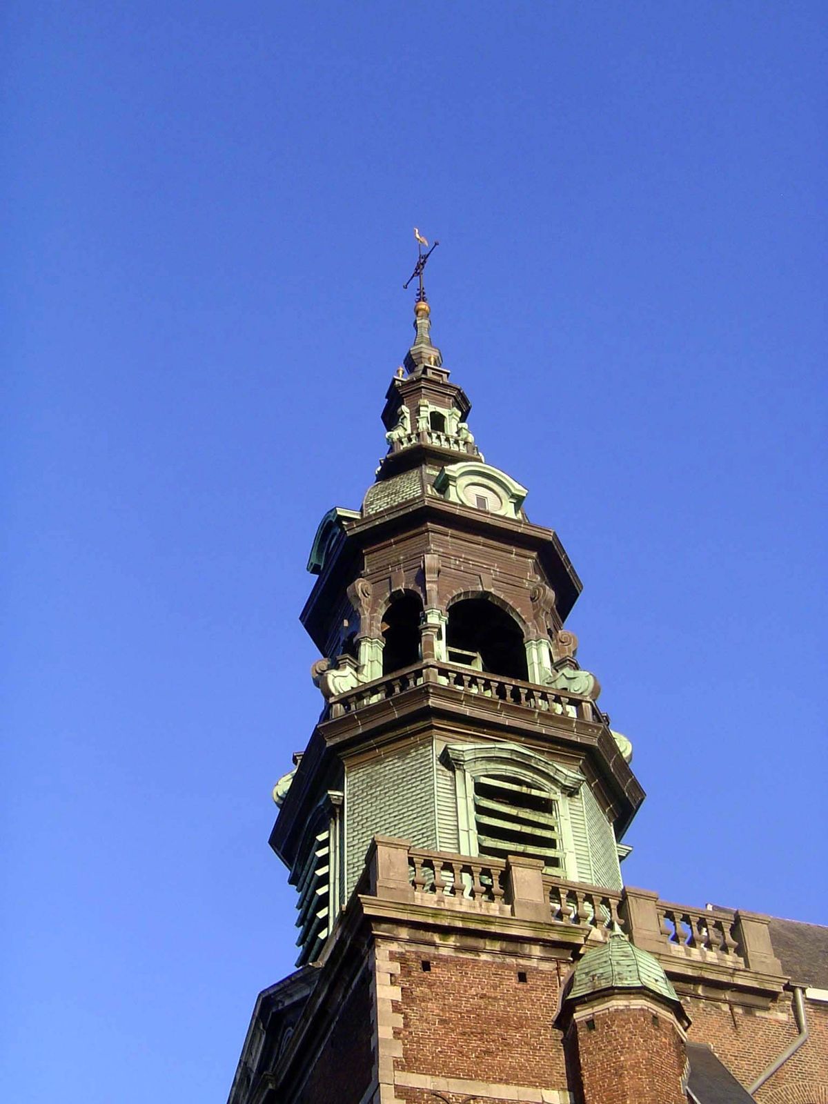 The belfry was erected early in the 18th century after a fire destroyed the existing church; in the 19th, copper shingles replaced the origi