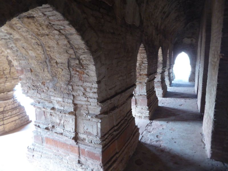 The structure consists of a central pyramid rimmed by three rings of arches, ten in the outer, five in the inner, eight in between. The arch