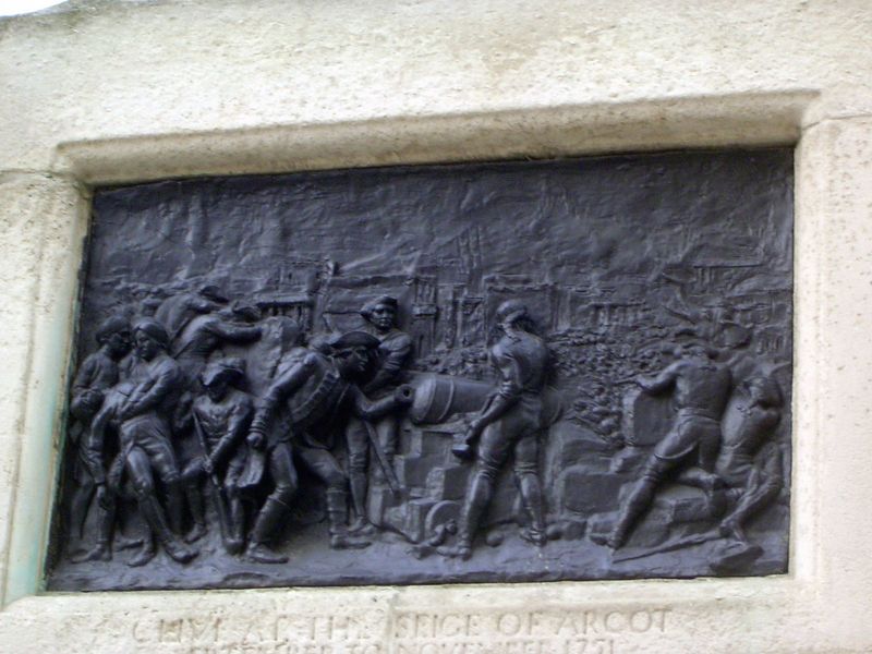 His career is illustrated at the base of the monument. An early triumph: "At the siege of Arcot."