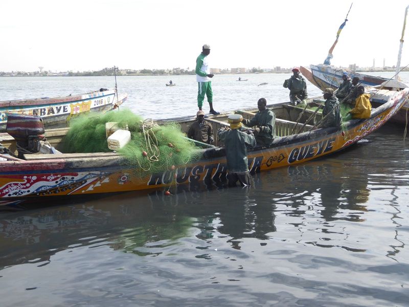 It's fishing season, and boats are arriving on the calm inside water of the Petit Bras.