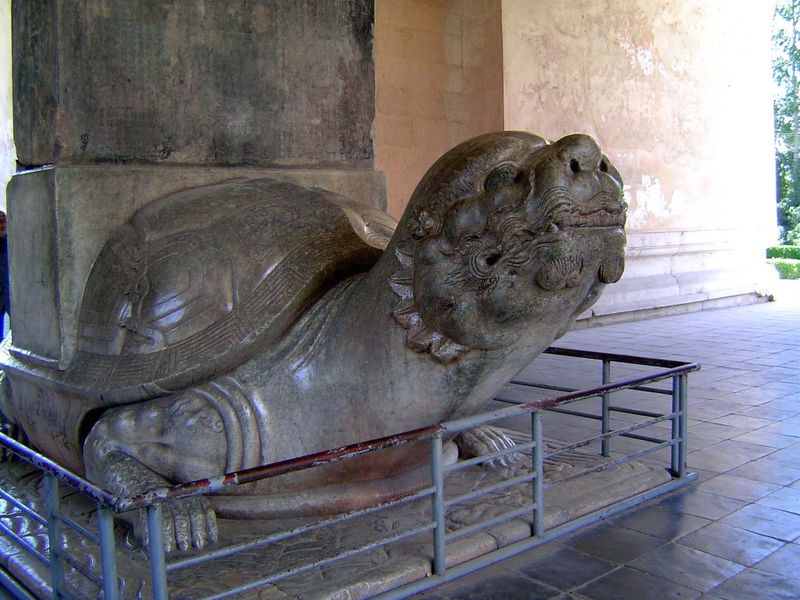 Strictly, it's not quite a turtle but a representation of bixi—half-turtle and half-dragon. Hence the fangs. Bixi was able to carry heavy lo
