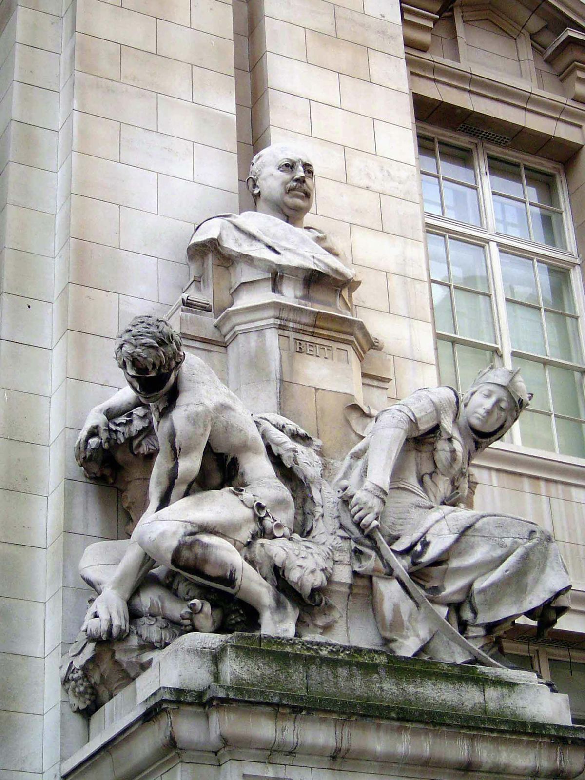 Beit was a founder of De Beers and an ally of Rhodes. Is the figure on the left digging for diamonds with his bare hands? Does the figure on