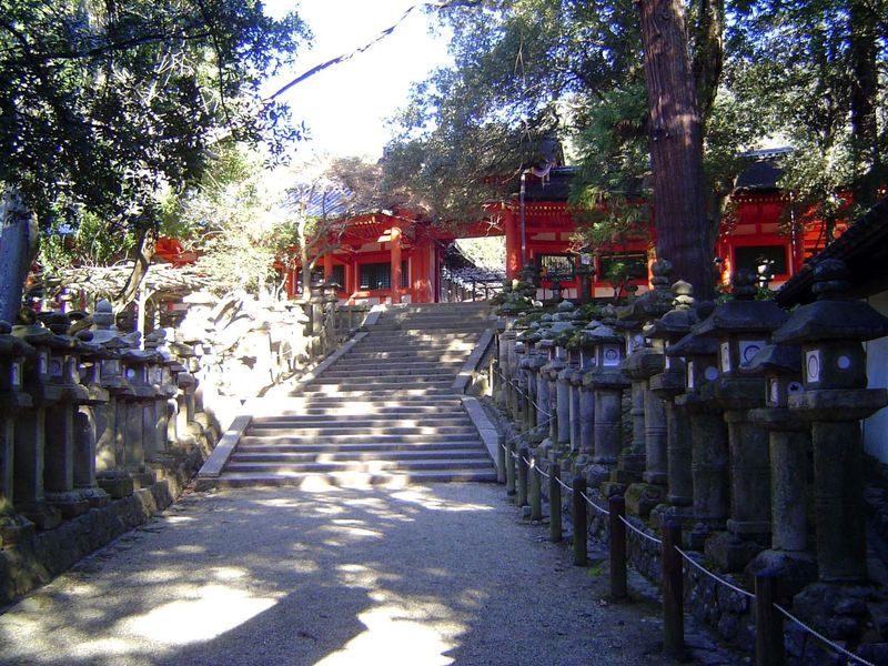 The path leads to a brightly colored gallery enclosing the shrines.
