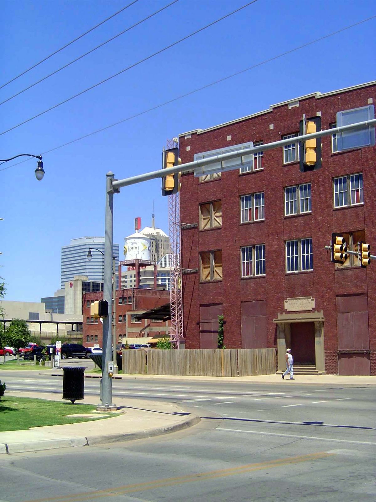 Looking northwesterly past another old warehouse to the Oklahoma First tower. The sidewalk and paving are surprisingly good, which should su