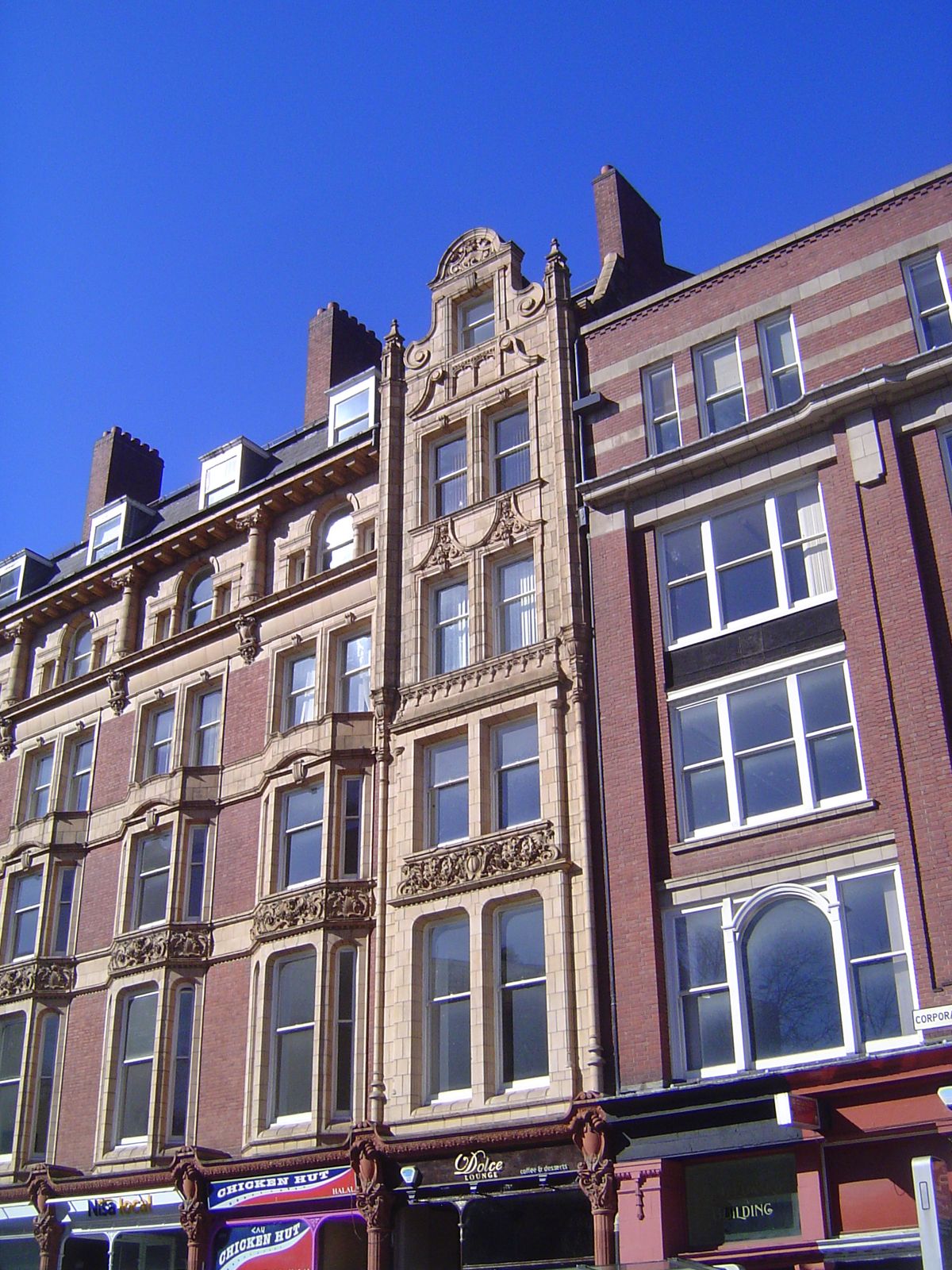 The building retains its original iron-pillar shop fronts.