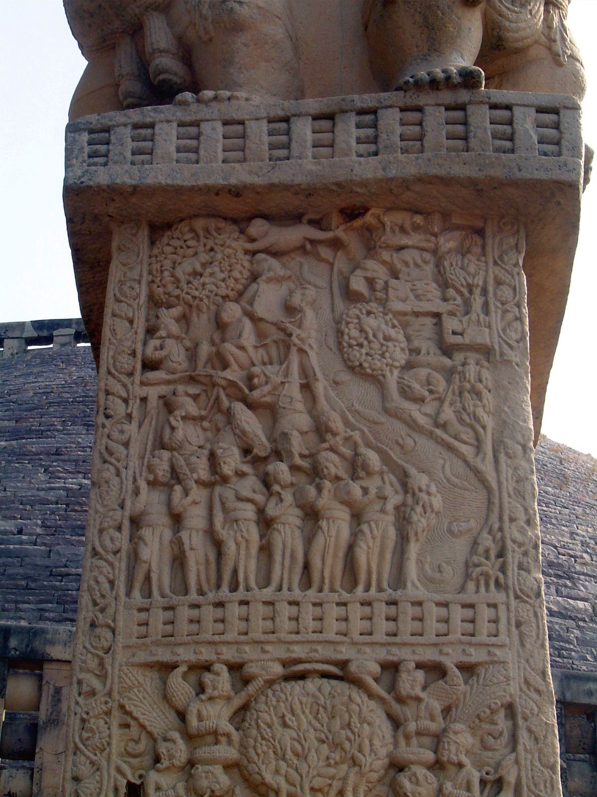 The front side of the south pillar of the west gate illustrates the Mahakapi jataka. Monkeys escape over a bridge made in part by the body o