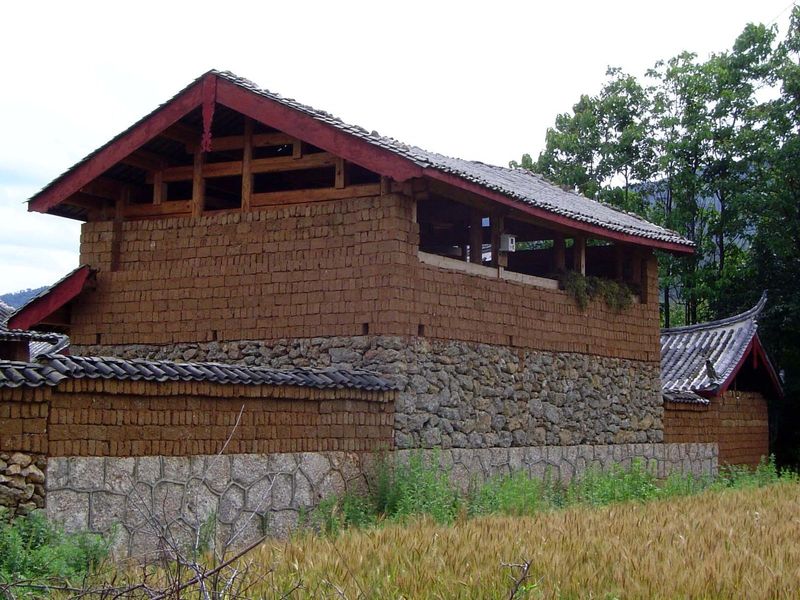 The farmsteads have a massive wooden frame, filled in with adobe bricks laid on stone foundations.