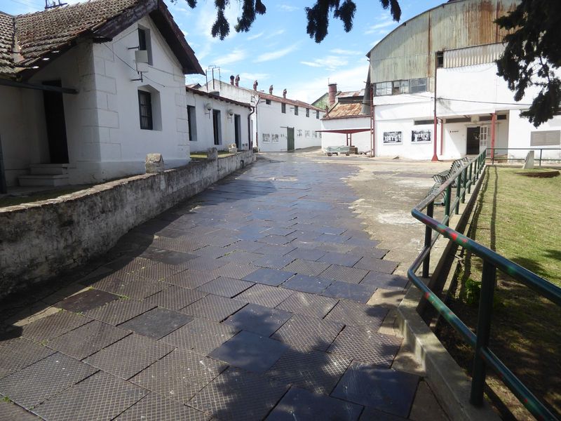 Looking from the office building further into the complex. The steel plates were imported as ballast, then laid here to protect the walkway.