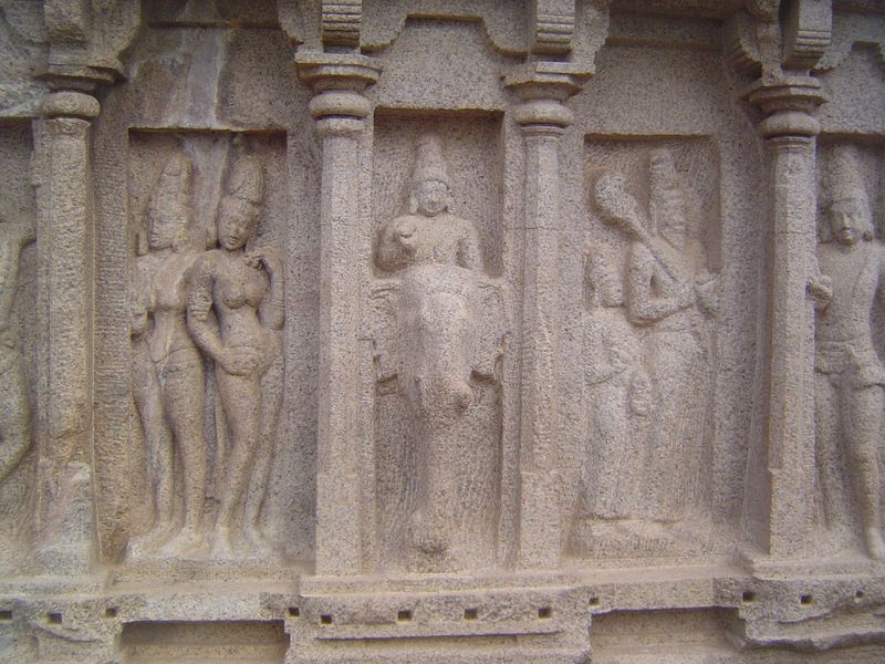 Some say that he is instead Subrahmanya, the god of war and victory. Two royal ladies are to his left; to the right are a sage and disciple.