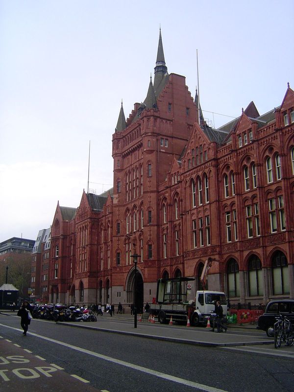 Another view. Pevsner writes of the "long symmetrical facade of fiery red brick and red terracotta, amply gabled, and with a big central win