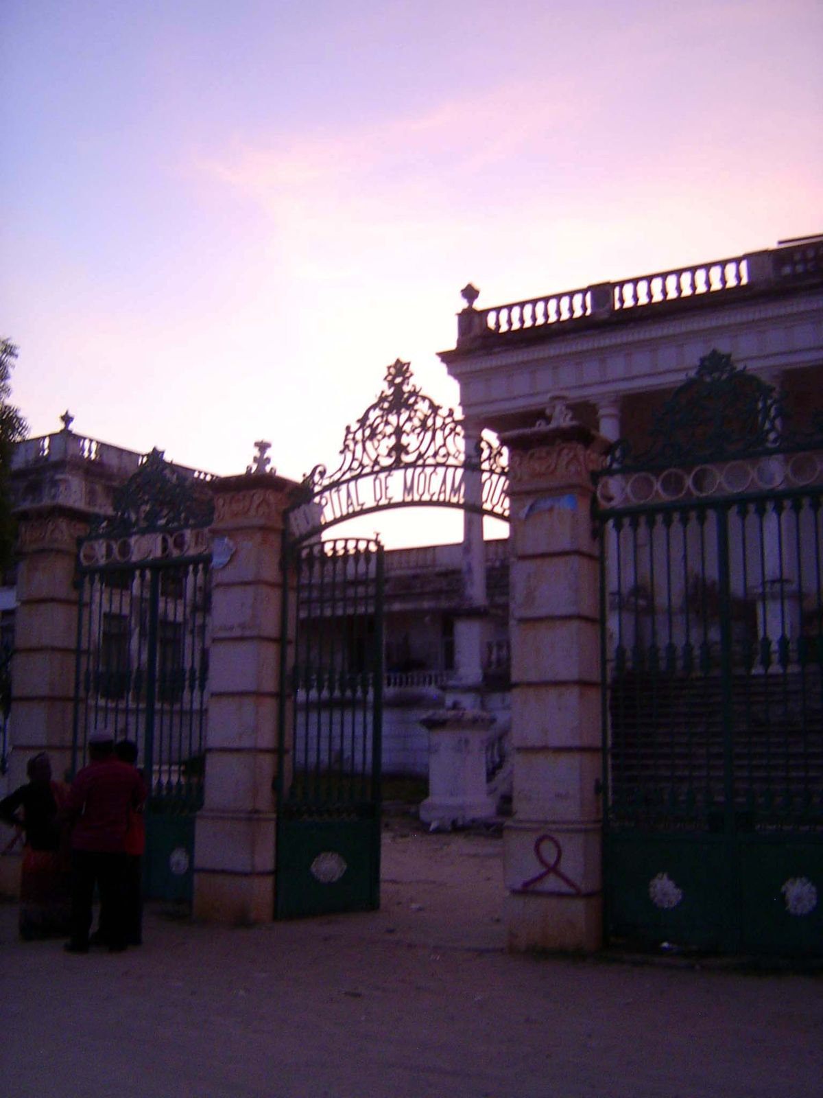 Wrought-iron entrance at dusk.