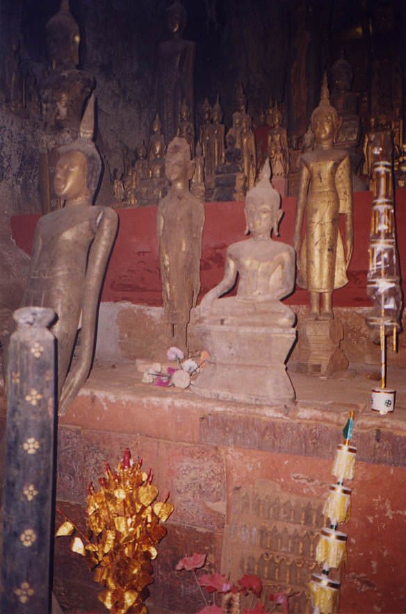 Thousands of such figurines fill the caves, dark except for the camera flash.