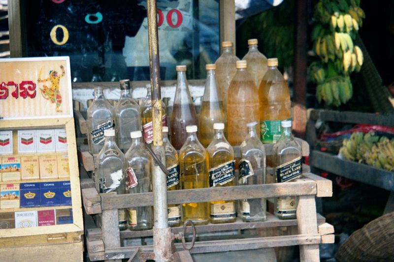 The Cambodians themselves shop in a market at the northeast corner of town. Here, in old whiskey bottles, is fuel for their motor scooters.