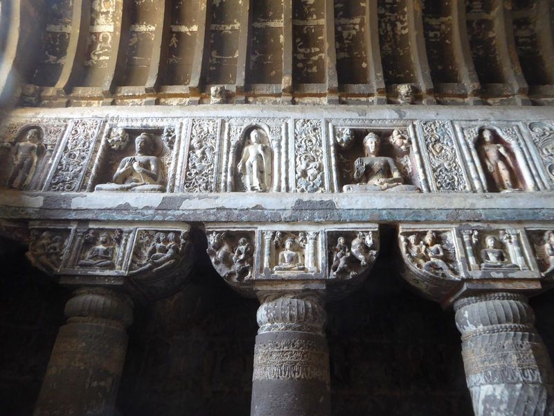Hardly an inch of the entablature is left alone. The sitting Buddhas are shown in two customary positions, the dharmachakra or teaching posi