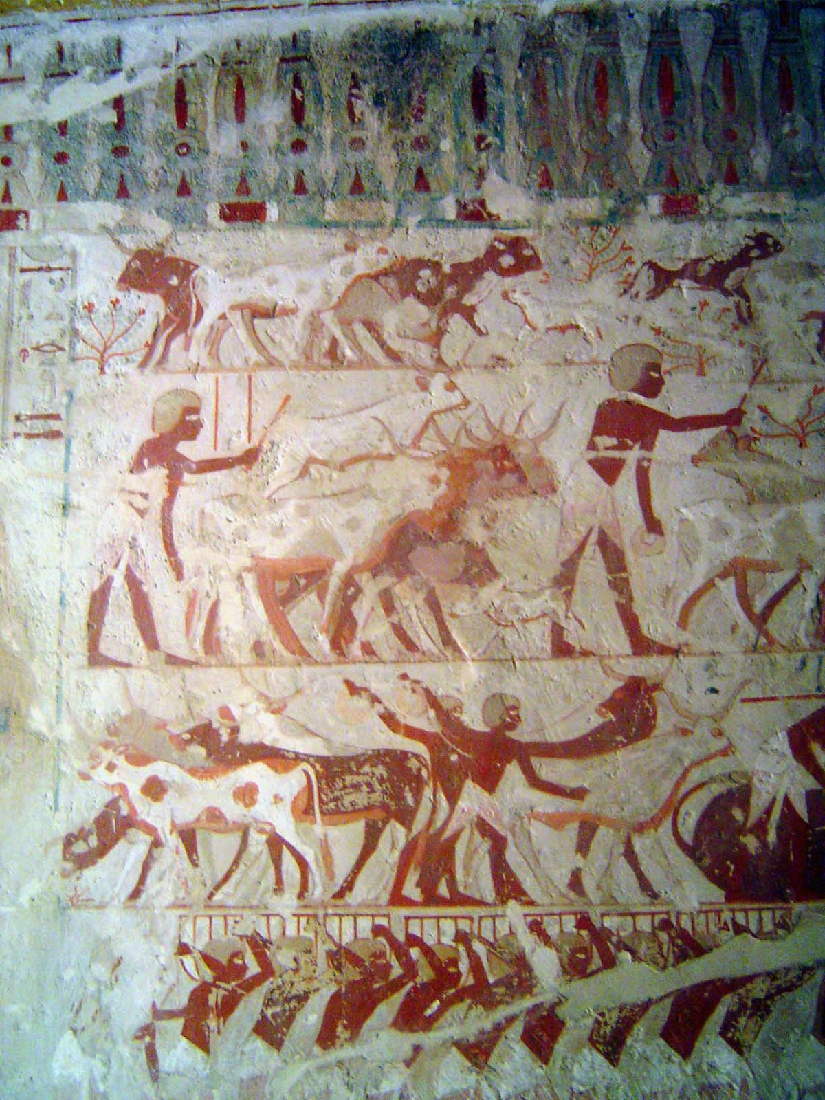 At the top, more gamboling calfs; below, their legs are tied and they are forced into order; at the base, baskets of grain are brought forwa