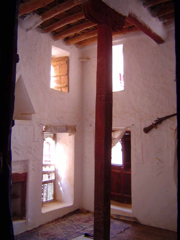 Deep-set windows havr no glass but are screened with the thorny ilb tree; windows are placed low on the wall for a better view of the street