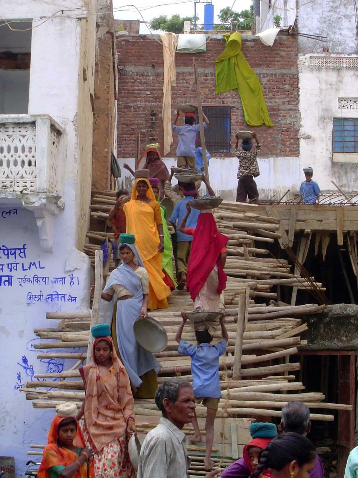 Tourists, gathering to watch, were shooed away by an annoyed contractor.