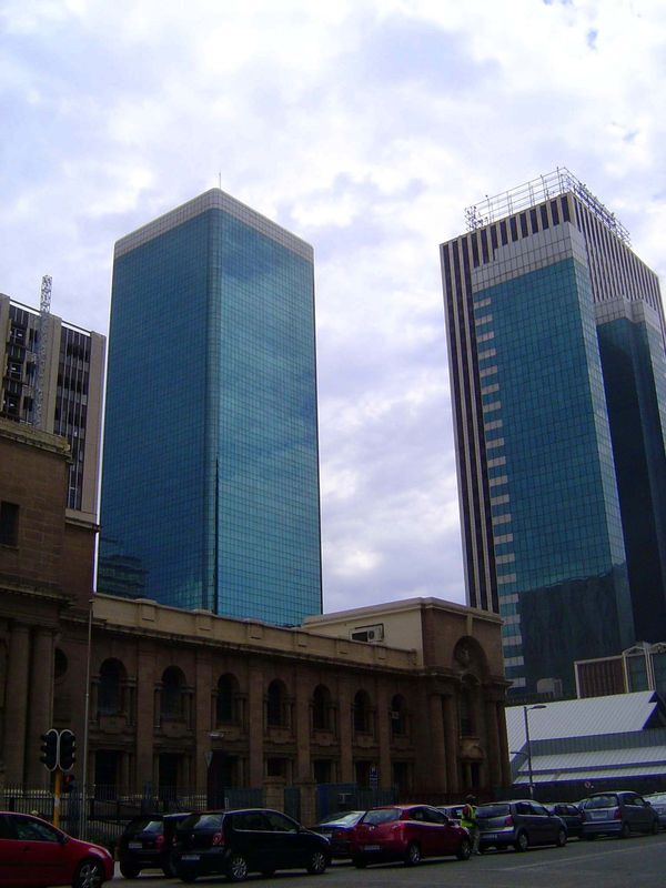 A few blocks north and rising behind the supreme court, the Tollman Tower on the left opened in 1970 to house the Johannesburg Sun hotel. Th