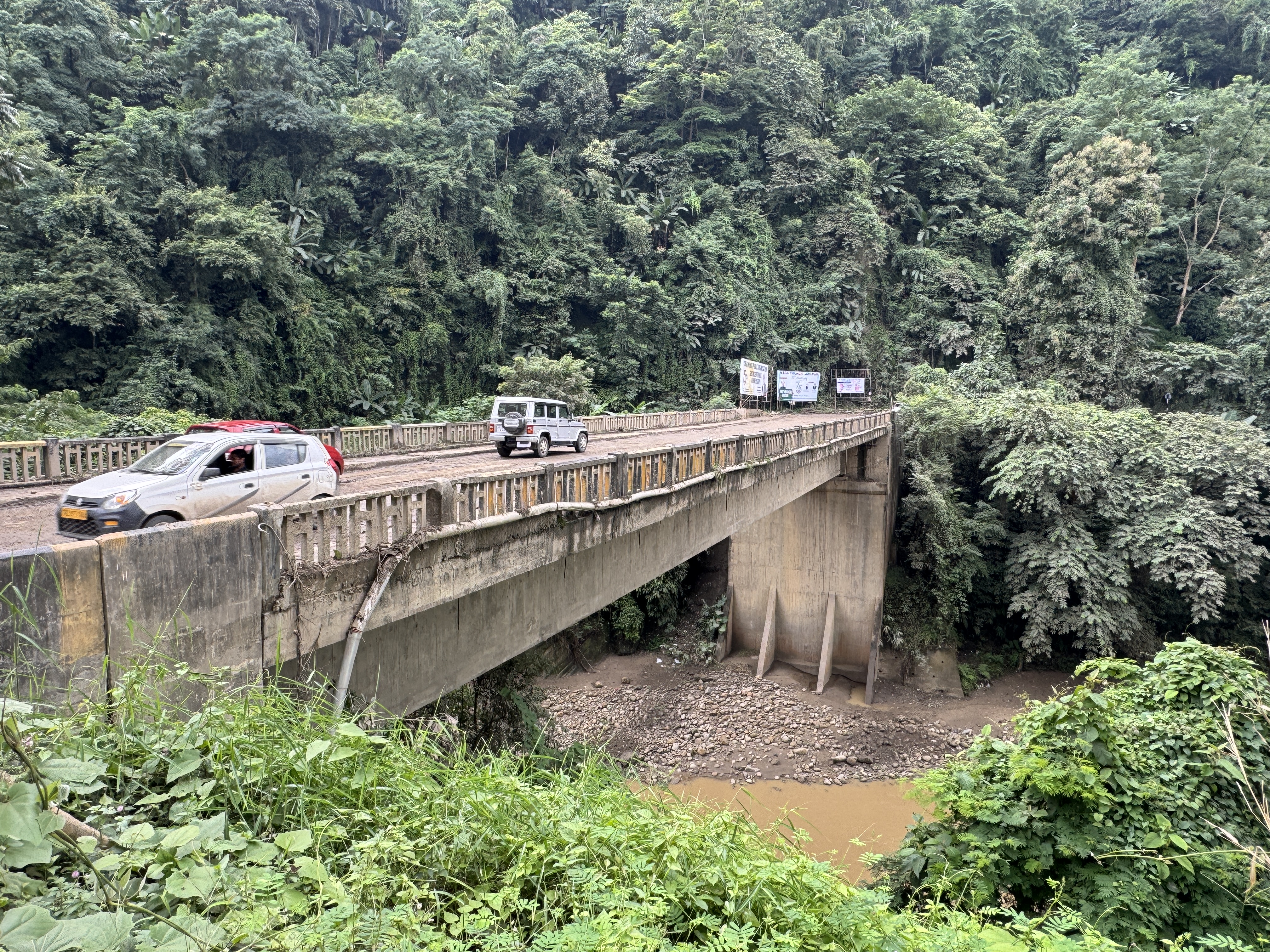 Ten miles east of Dimapur and at the Patkai Bridge over the Chathe River, the straight highway across the Brahmaputra Valley begins writhing