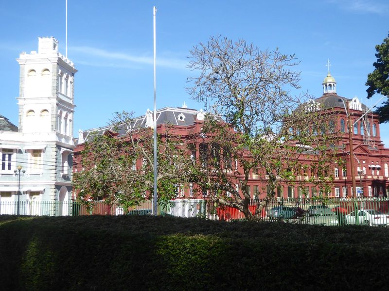 The view diagonally from the cathedral grounds to the old fire station and the Red House, now the seat of Trinidad's parliament. It faces Wo