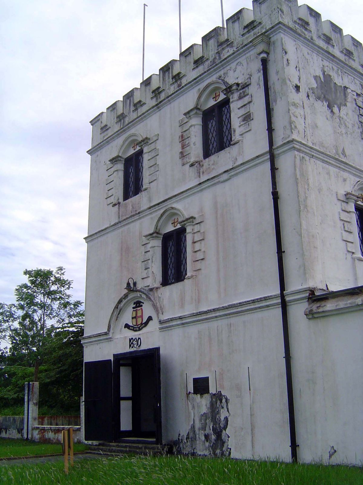 The entrance bears the date 1890 and the Brooke shield, now the shield of Sarawak State.