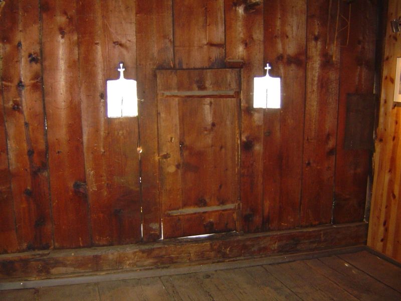 Top floor of house, with door to flower-trimmed balcony.
