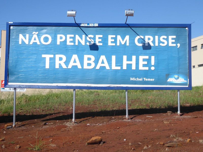 Money in Brazil in mid-2016 was tight for a lot of people. The president's message on many billboards seemed a little ambiguous, though: sur