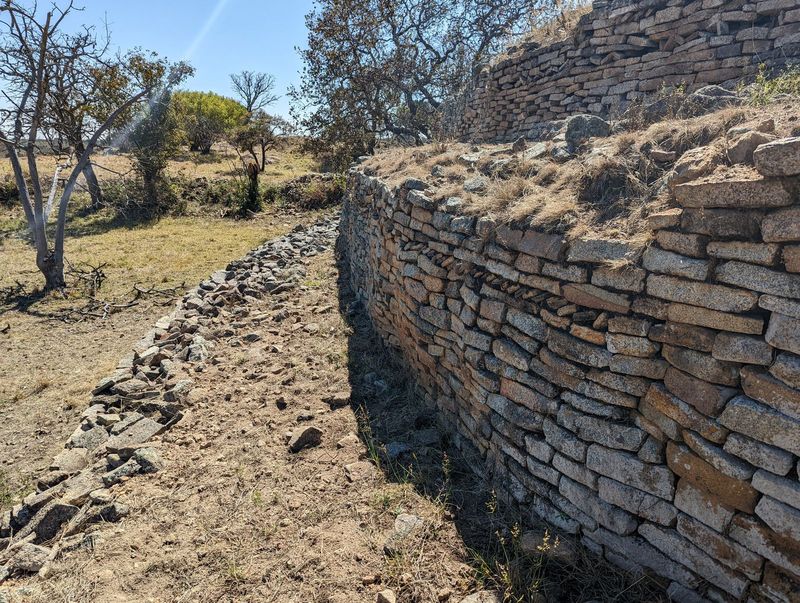 The drama today is all in the terrace walls, but they have been recently repaired, as at the Khami Ruins. The lichen-test suggests that this