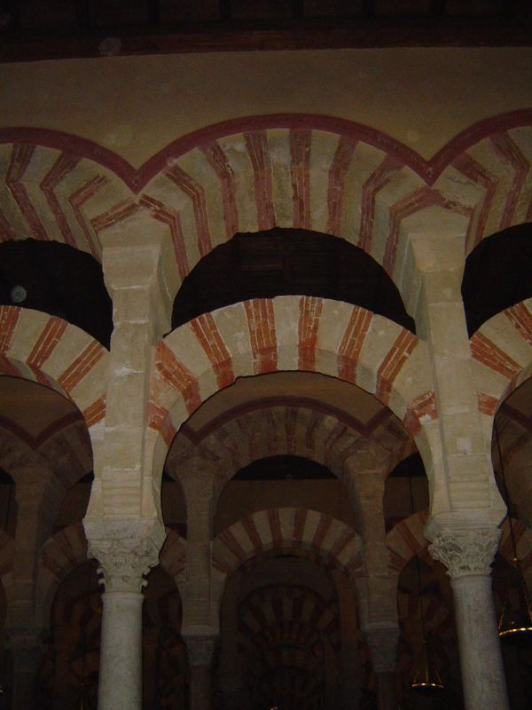 The columns support double-decked arches—the upper circular, the lower slightly horseshoe-shaped. It's a design adapted from Roman aqueducts