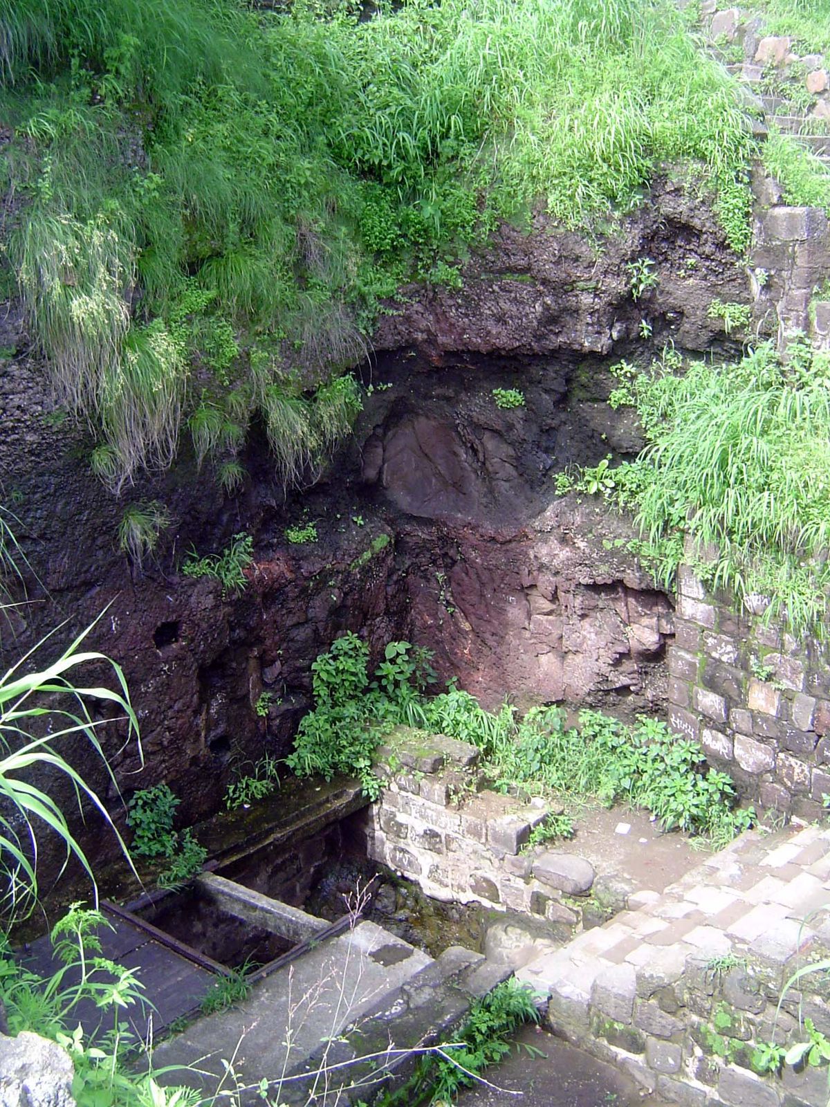 The staircase emerges atop the cliff. Ibn Battuta adds, "At the head of the passage is a large grating of iron which is shut down in case of