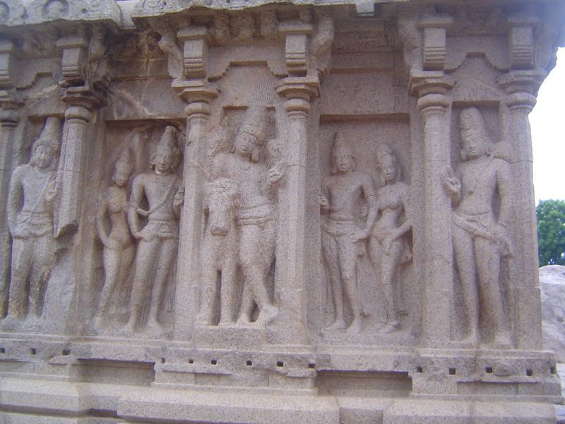 On the south side, Shiva leans on Nandi and is flanked by royal couples and, perhaps, directional deities.