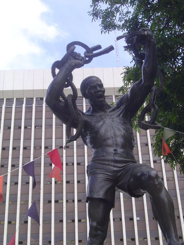 The figure is of mythical proportions but portrays the real "Zanco" Mutembo, who is said to have been arrested by the British in 1963 and to