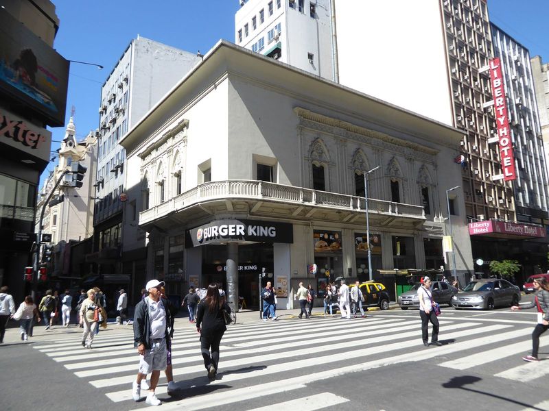 In the midst of this would-be Paris, there are reminders of an older city. Here, at the busy corner of Florida and Corrientes is the former 