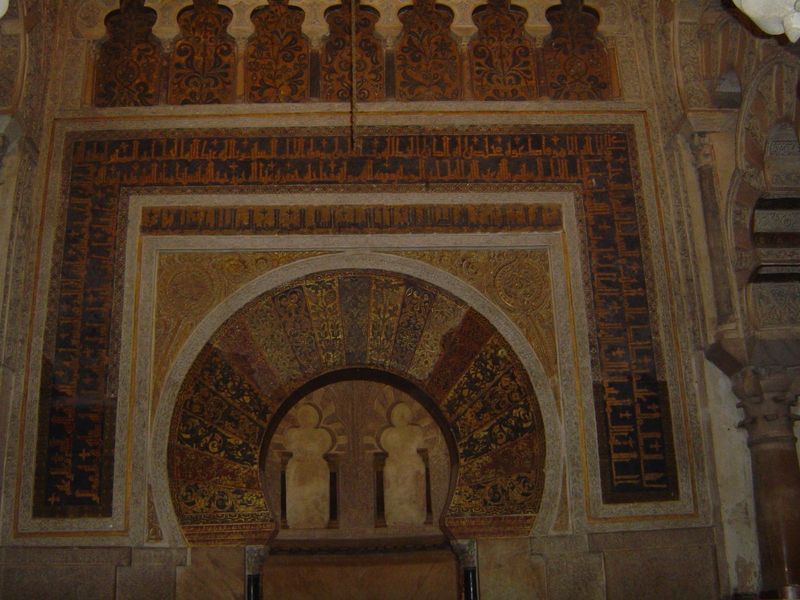 The mihrab has a horseshoe arch surrounded by an alfiz, the distinctive U-shaped band of trim, in this case ornamented with squarish Kufic s