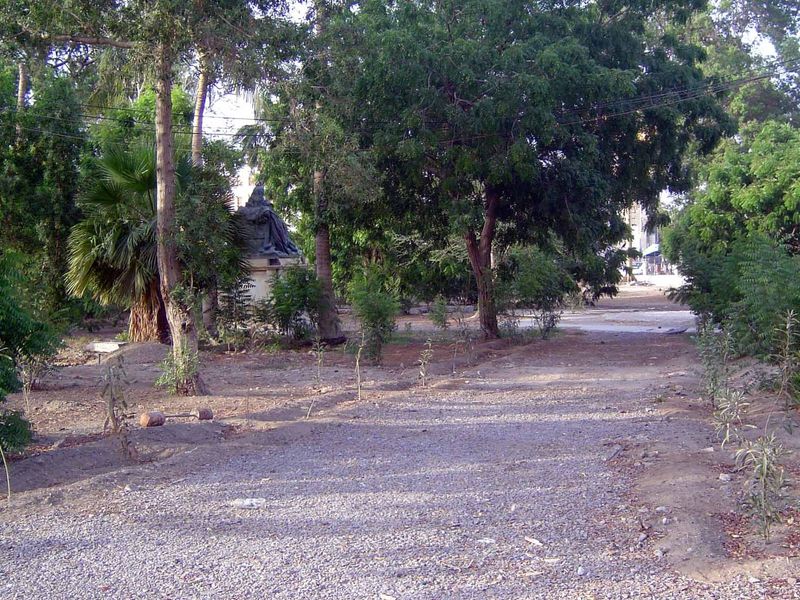 It needed a park, too. Can you make out that object in the trees on the left? It's a dark mass atop a light-colored base.