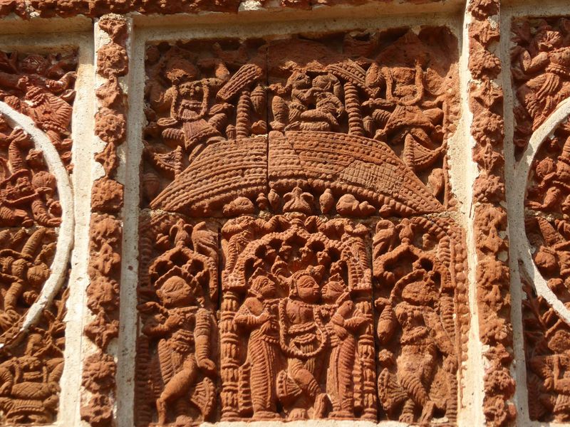 Here it again, with Krishna and Radha both above and below a roof. In other words, the panel shows a two-tiered temple, just like the one it