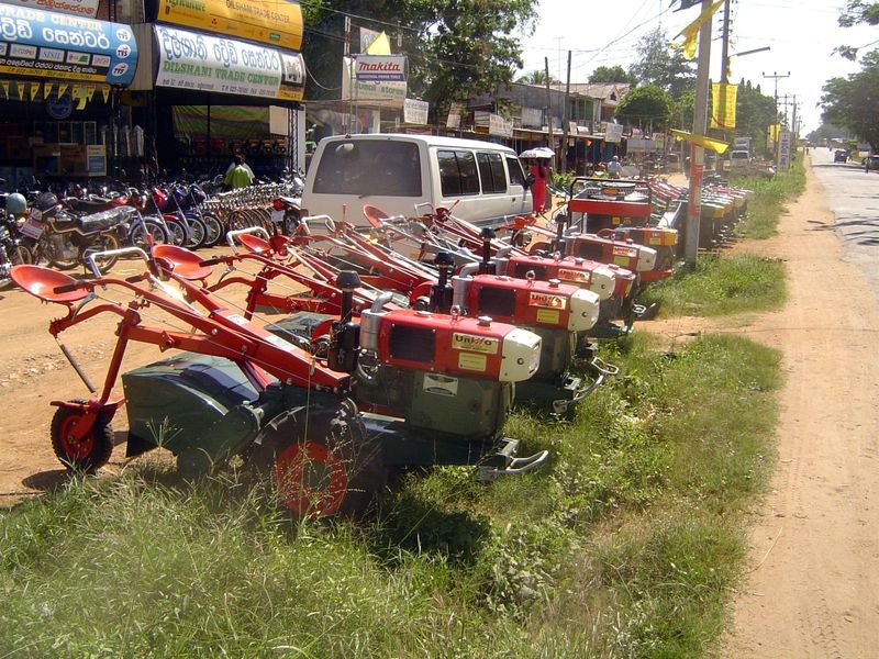 Across the road, these Chinese-made hand tractors, hint at one source of that income.