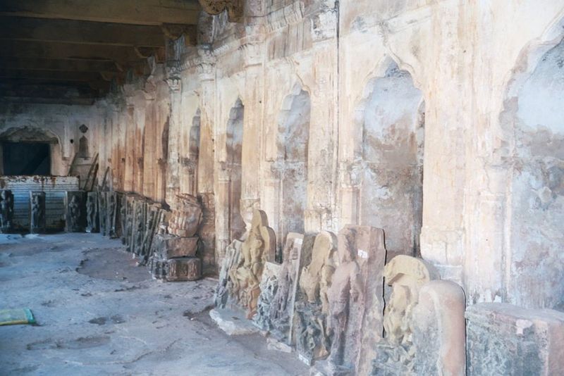 Under the arcade, decorative slabs in storage.