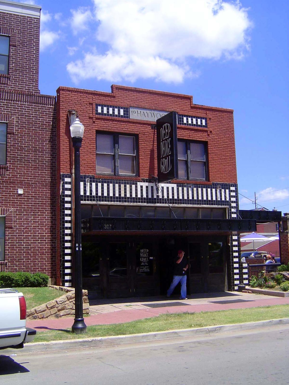 Adjoining the apartments is the Deep Deuce Grill, at 307 NE 2nd. The building is from 1938 and was sold by the Renewal Authority to Second S