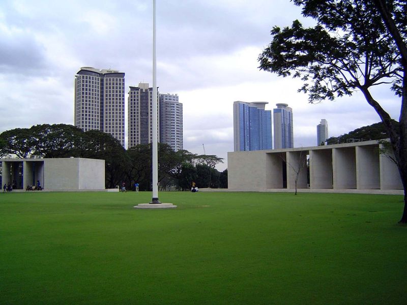 In the center and with Bonifacio Global City in the background, there's a monument consisting chiefly of two travertine hemicycles around a 