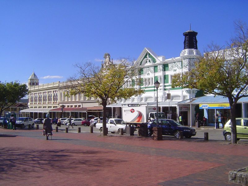 The commercial buildings facing the town hall seem modest in comparison, though they are not exactly self-effacing.