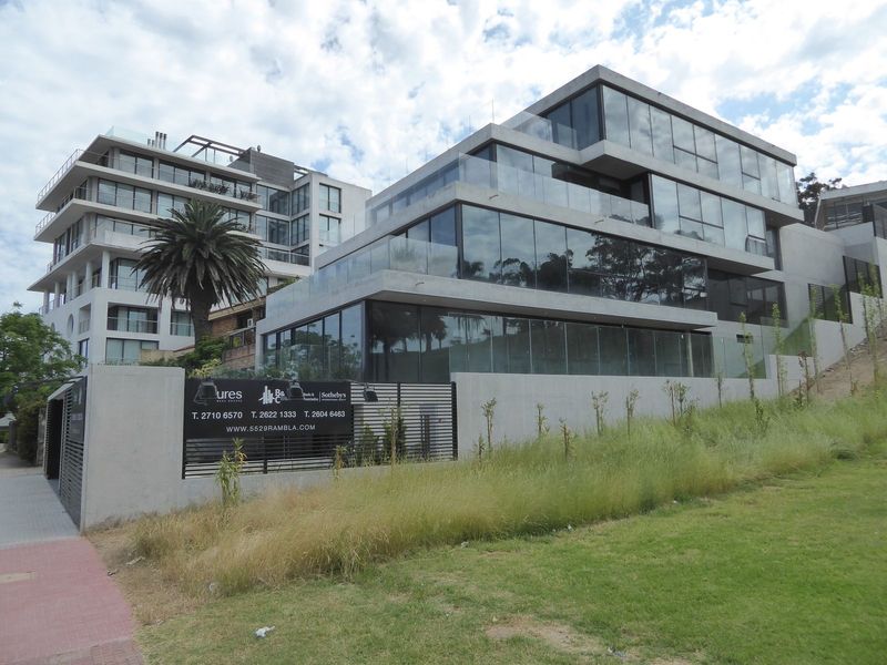 We've come another mile along the coast to just below the Plaza do Armada Nacional. Here's a building with four apartments, each priced a bi