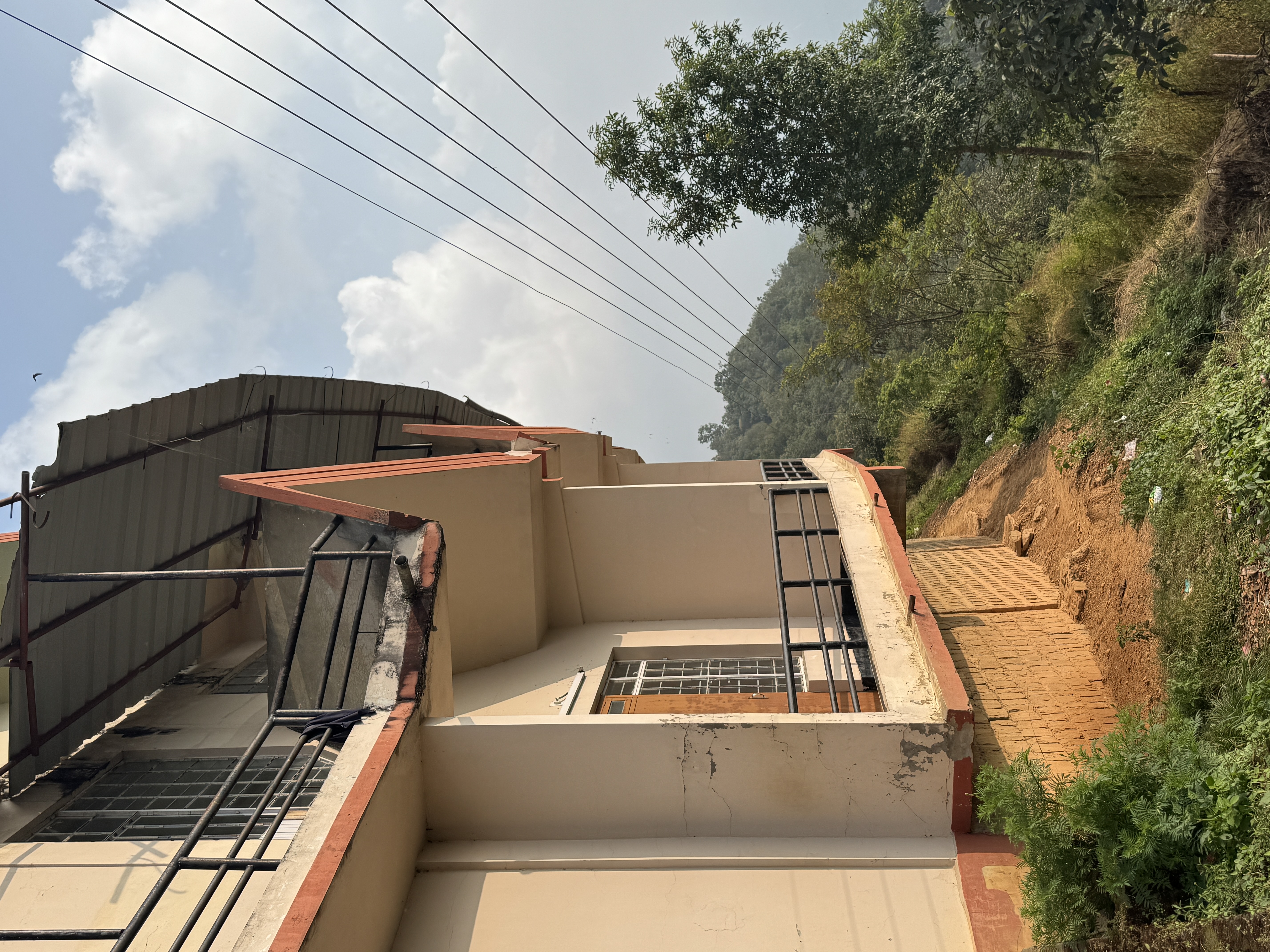 The lodge was built at the end of a ridge overlooking valleys to the east and west.  There's a great view of Kohima, but on this day mist go