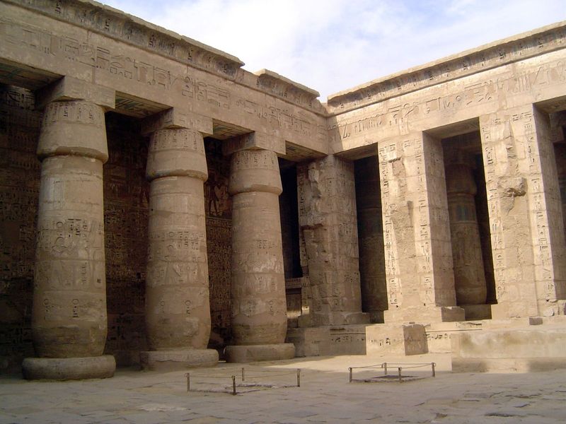 Defaced Osirid columns on the west face of the second courtyard.